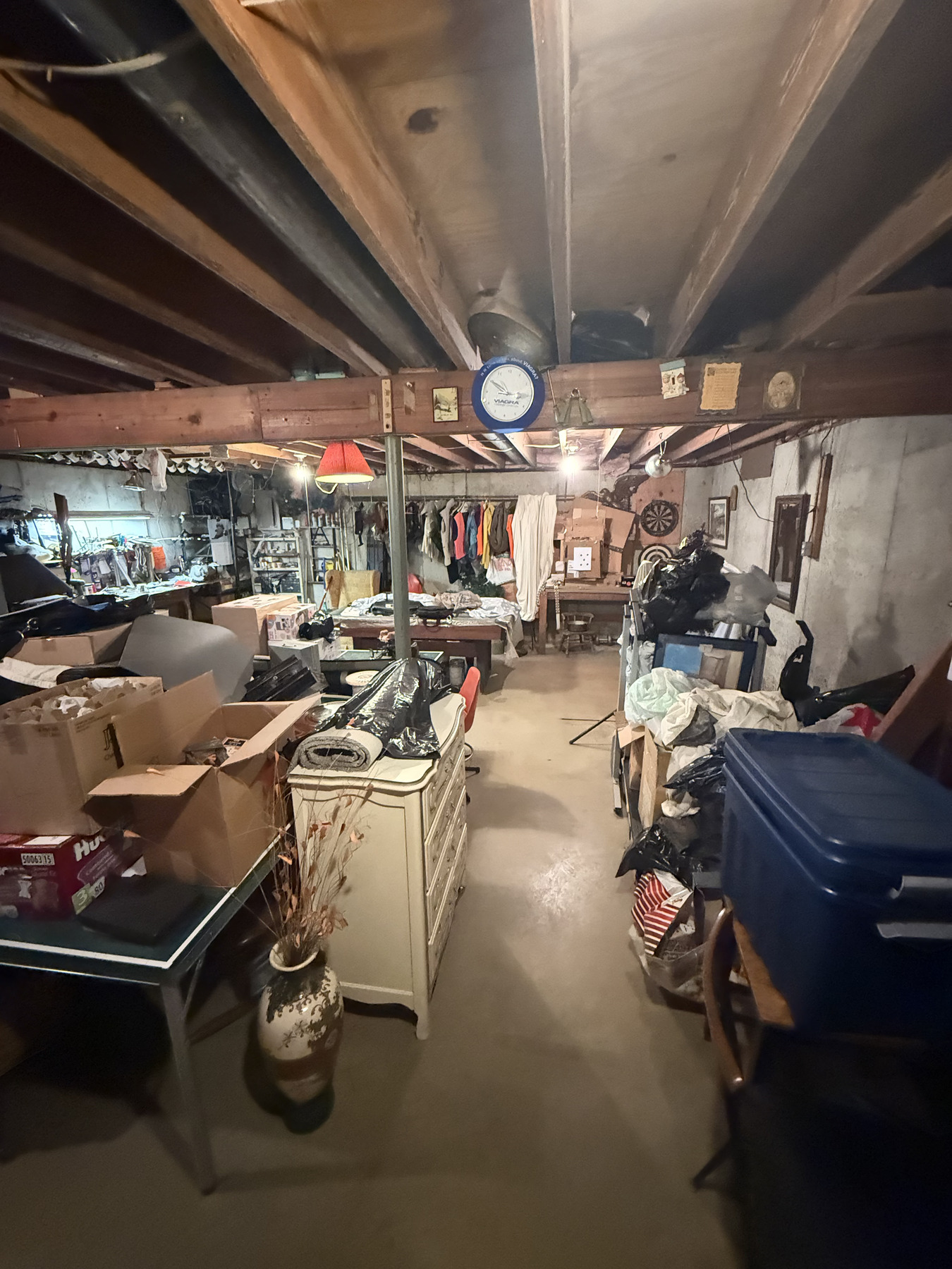 Fort Wayne basement packed with furniture, boxes and stored belongings before a cleanout