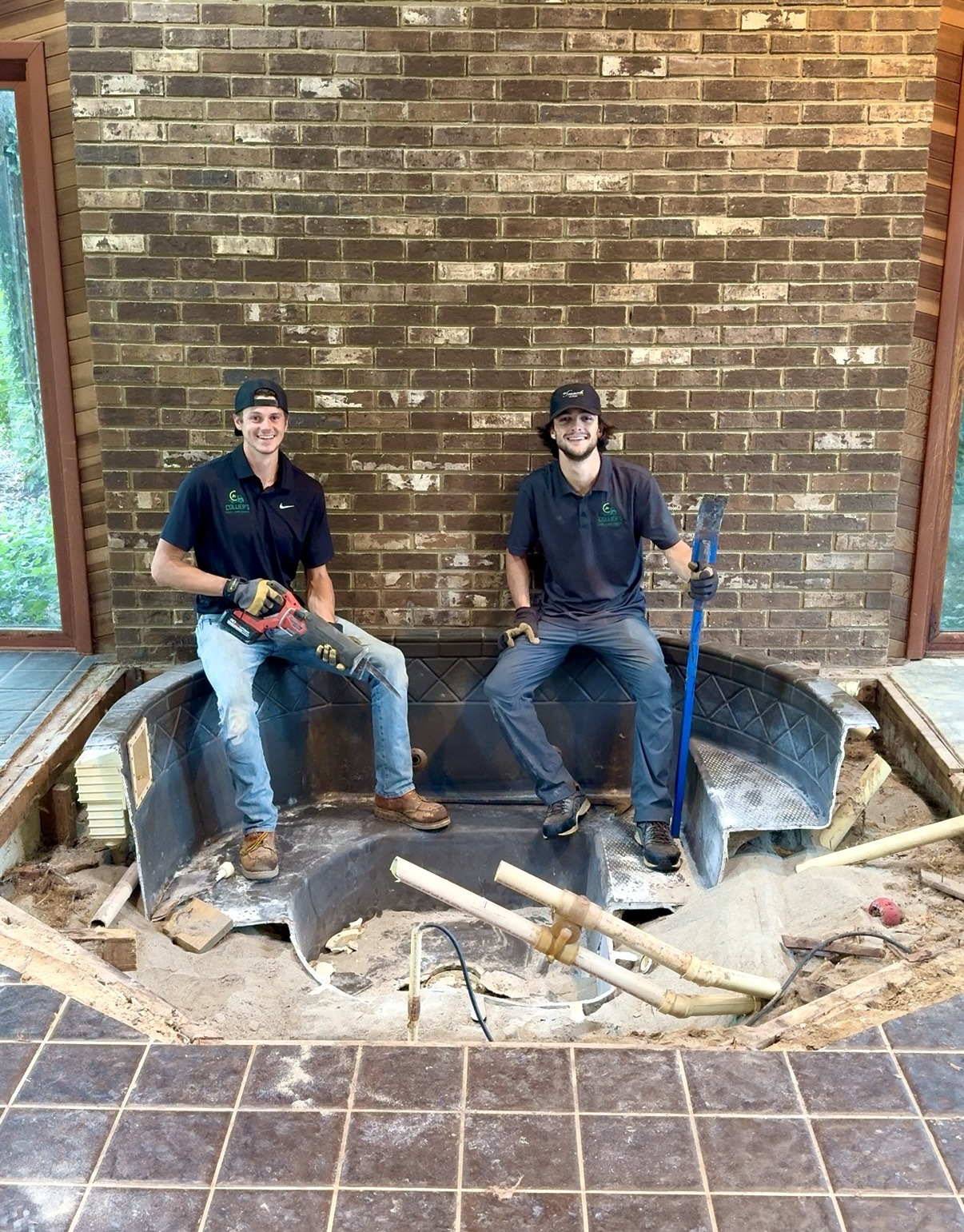 Collier's crew sitting on an indoor sunken spa removed from a brick sunroom floor