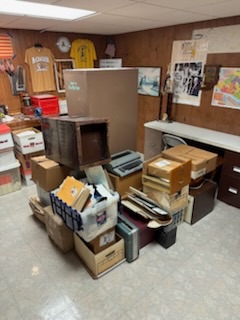Basement storage room cluttered with boxes before cleanout