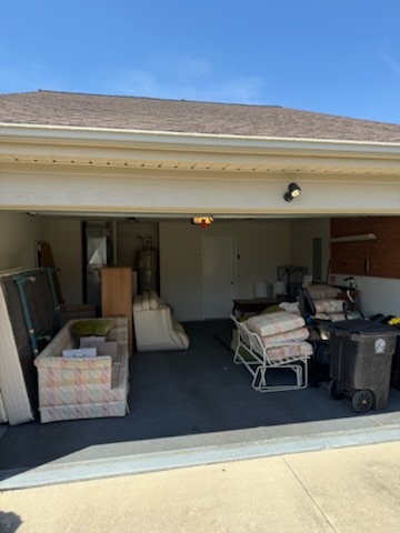 Garage filled with furniture and debris before removal