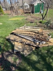 Pile of fence and wood debris in yard before removal